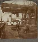 Unloading an ore-steamer at Cleveland, O. -- lowering a 5-ton electric clam into the hold