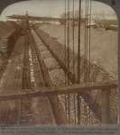 Piles of iron-ore between docks of Lake steamers (right) and railways to mills, Conneaut, Ohio