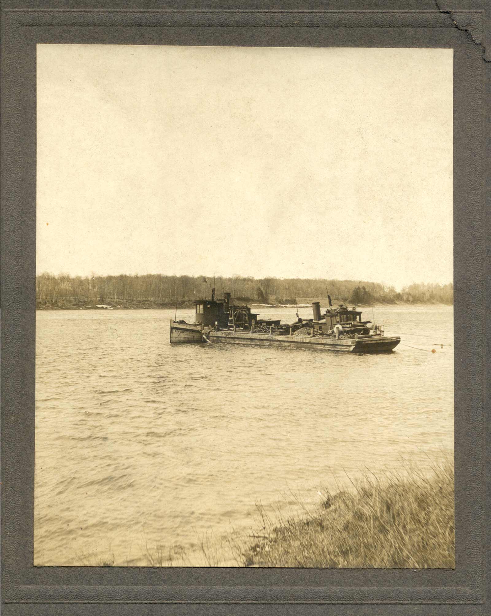 Two tugboats and a barge