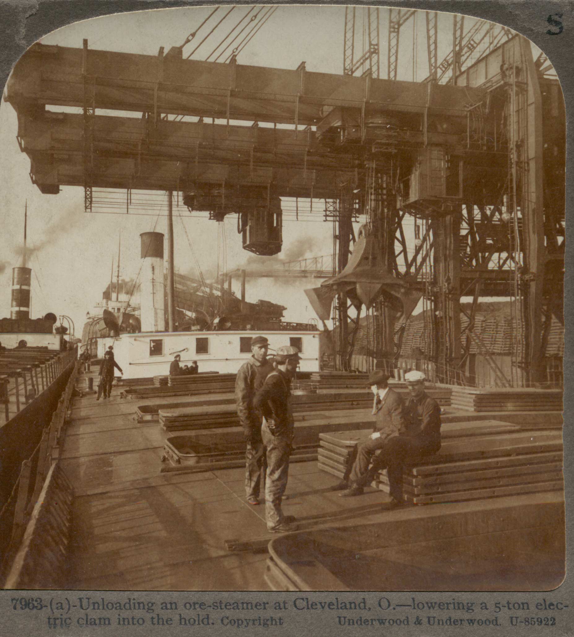 Unloading an ore-steamer at Cleveland, O. -- lowering a 5-ton electric clam into the hold