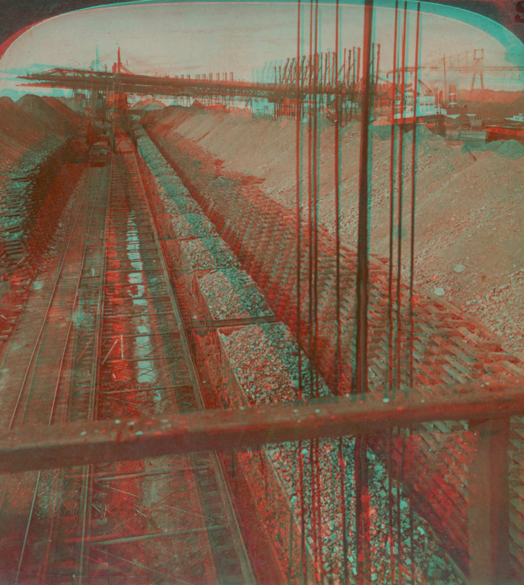 Piles of iron-ore between docks of Lake steamers (right) and railways to mills, Conneaut, Ohio