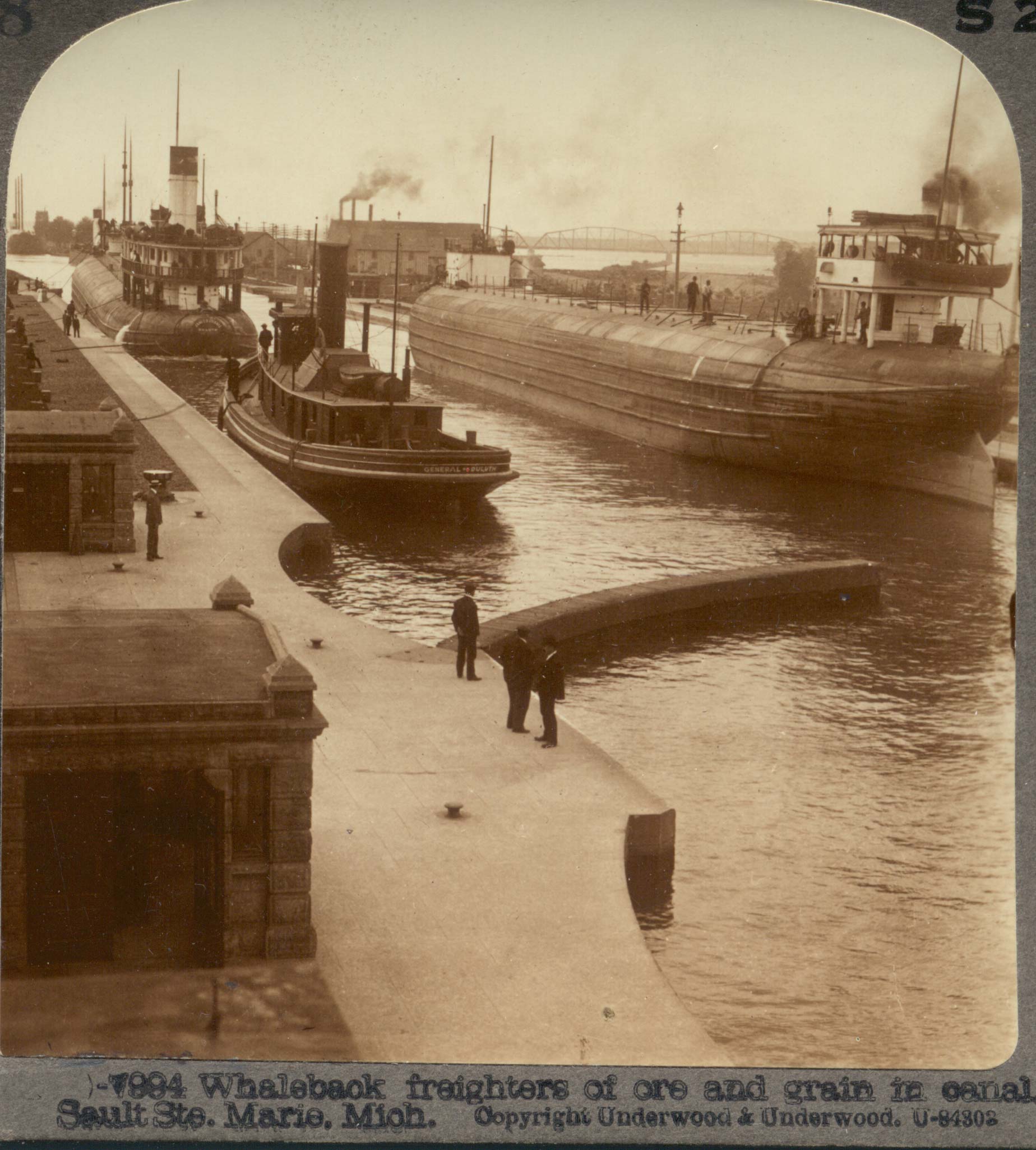 Whaleback freighters of ore and grain in canal, Sault Ste. Marie, Mich.