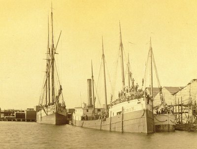 ERIN and MAGGIE in port with a three-masted schooner