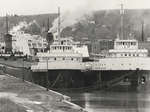 Martha Hindman and Parker Evans in Owen Sound, with the Chi-Cheemaun in the background.